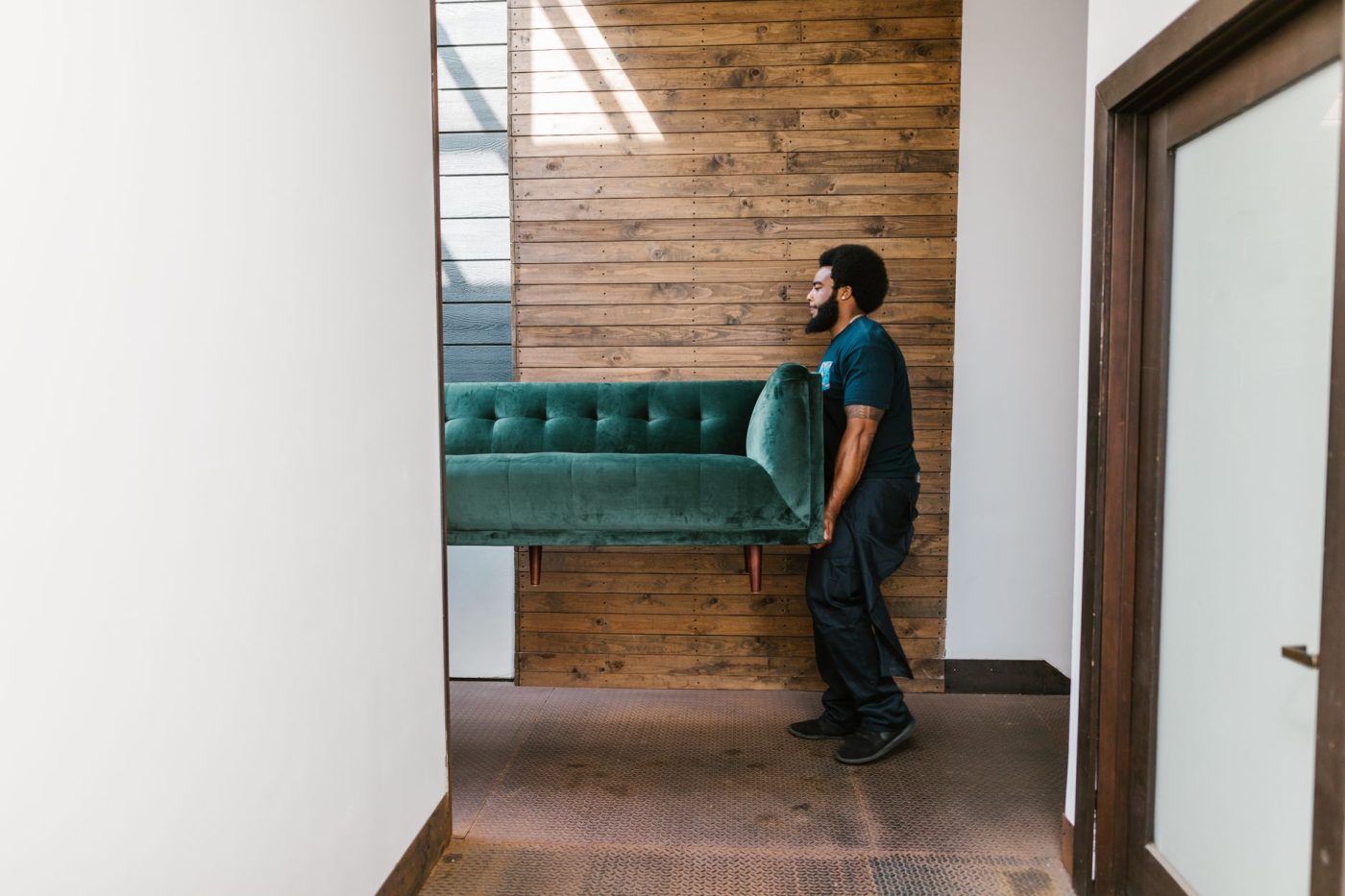 Professional movers carefully disassemble a heavy pool table in a residential game room before a local move.